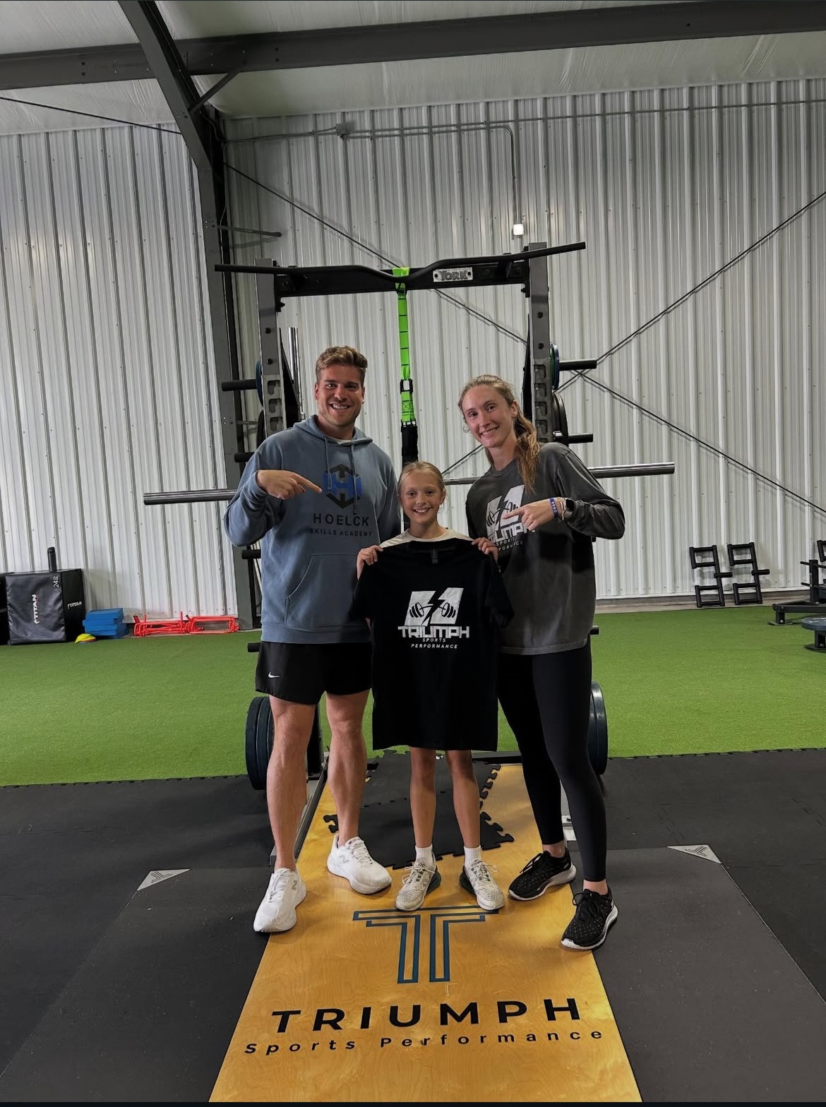 Young athlete celebrating with the Triumph coaching team